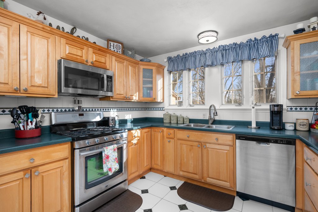 215 West Prospect Street Kewanee, IL 61443 - Photo 20 of 53 a kitchen with granite countertop a stove sink microwave and cabinets