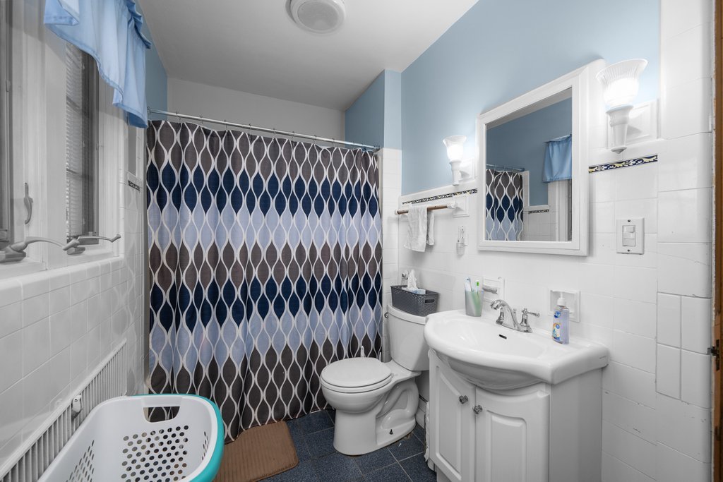 215 West Prospect Street Kewanee, IL 61443 - Photo 32 of 53 a bathroom with a sink toilet and a mirror