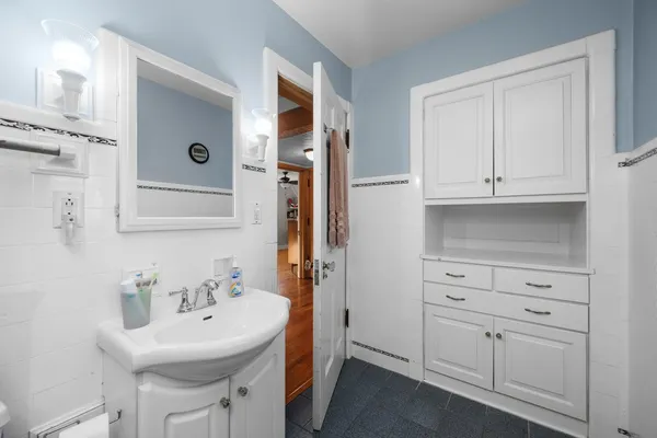 a bathroom with cabinets a sink and a mirror