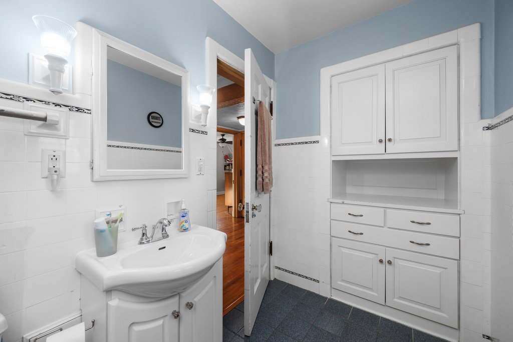 215 West Prospect Street Kewanee, IL 61443 - Photo 33 of 53 a bathroom with cabinets a sink and a mirror