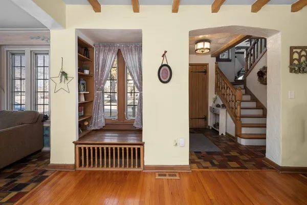 a view of entryway and hall with wooden floor
