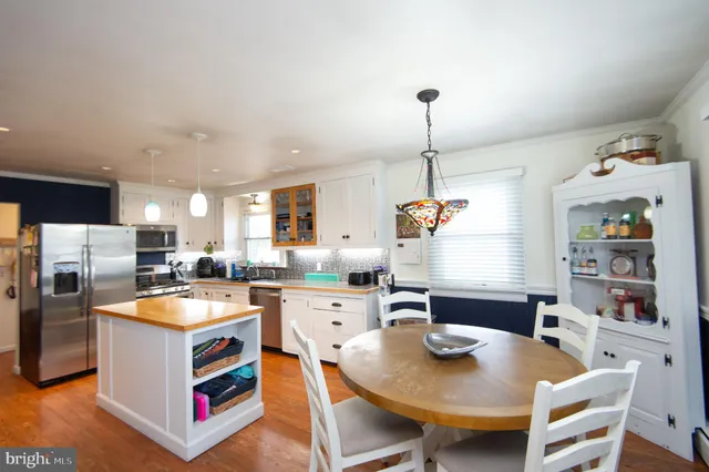 a open kitchen with stainless steel appliances granite countertop a stove and a refrigerator