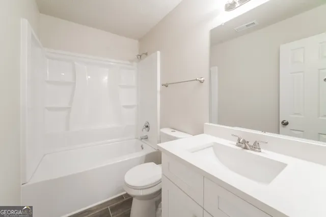 a bathroom with a sink a toilet and a bathtub