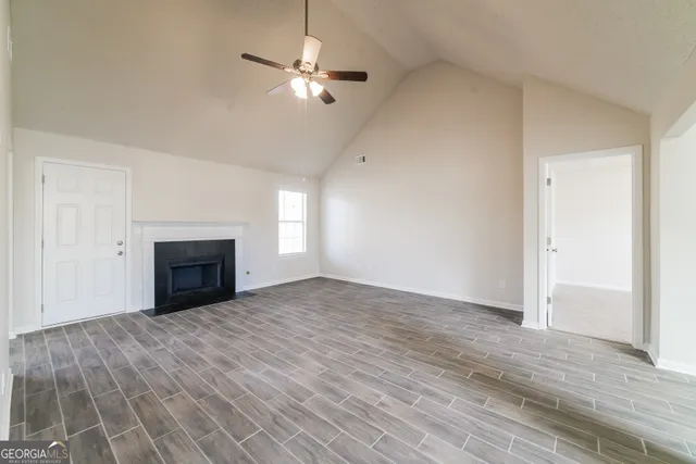 wooden floor fireplace and natural light in room