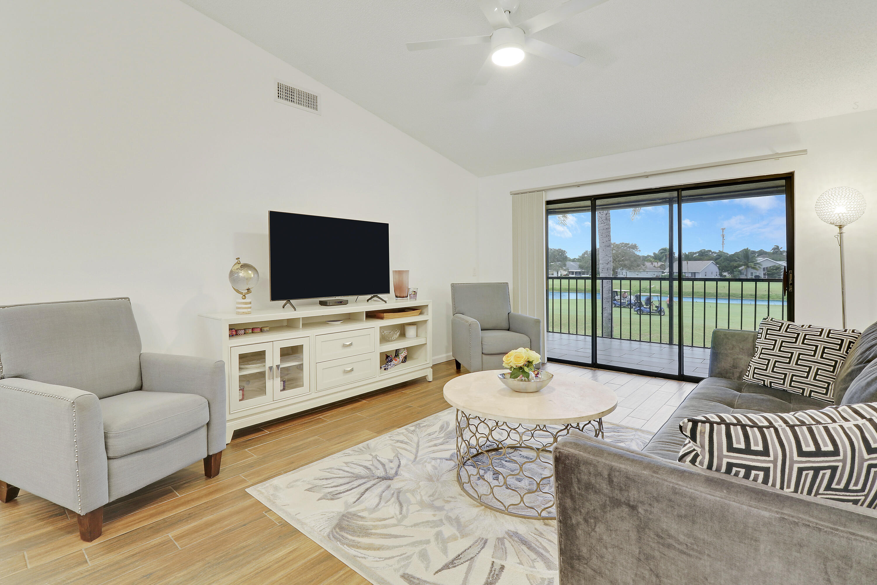 1112 Keystone Drive, Unit A Jupiter, FL 33458 - Photo 3 of 41 a living room with furniture and a flat screen tv