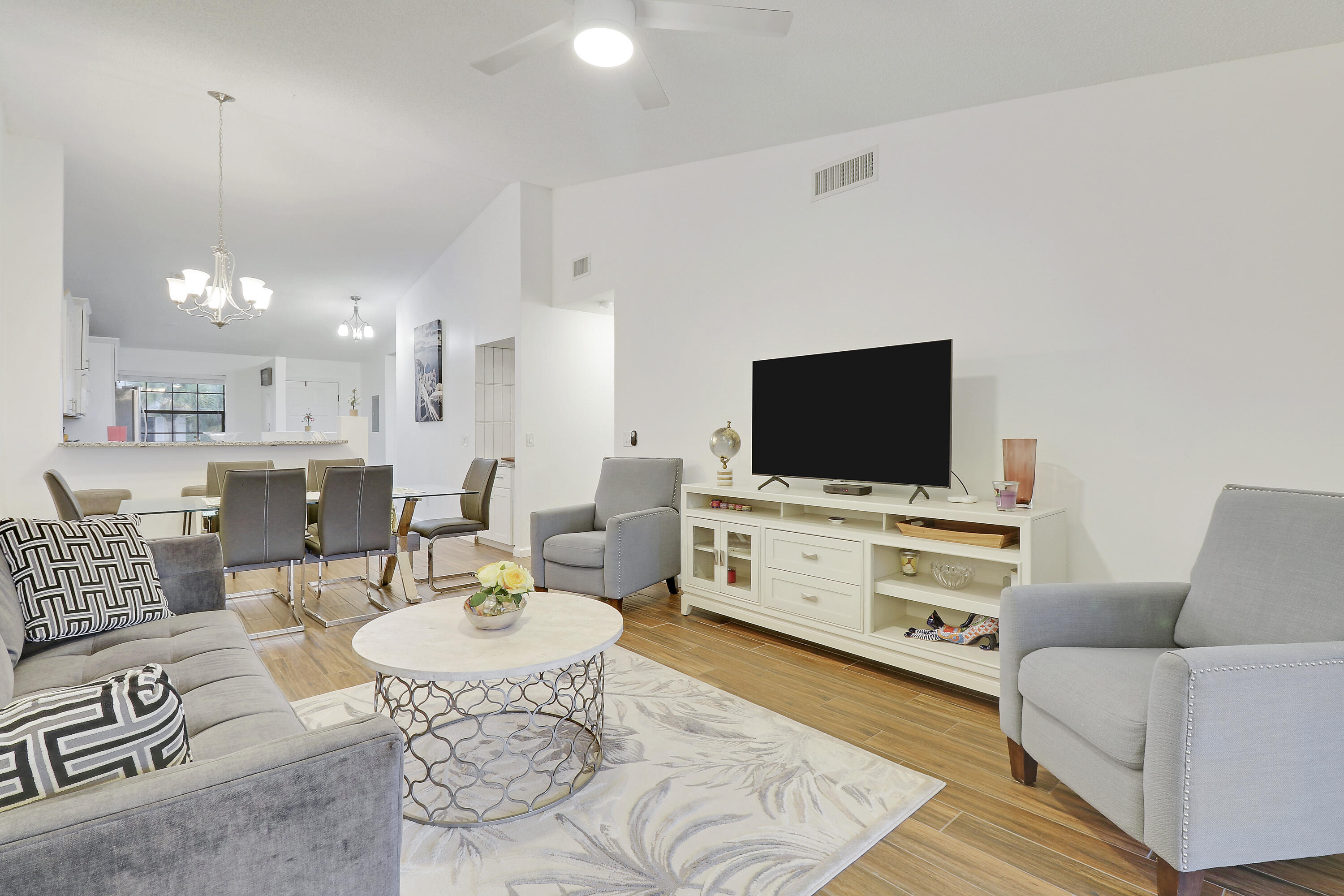 1112 Keystone Drive, Unit A Jupiter, FL 33458 - Photo 5 of 41 a living room with furniture and a flat screen tv