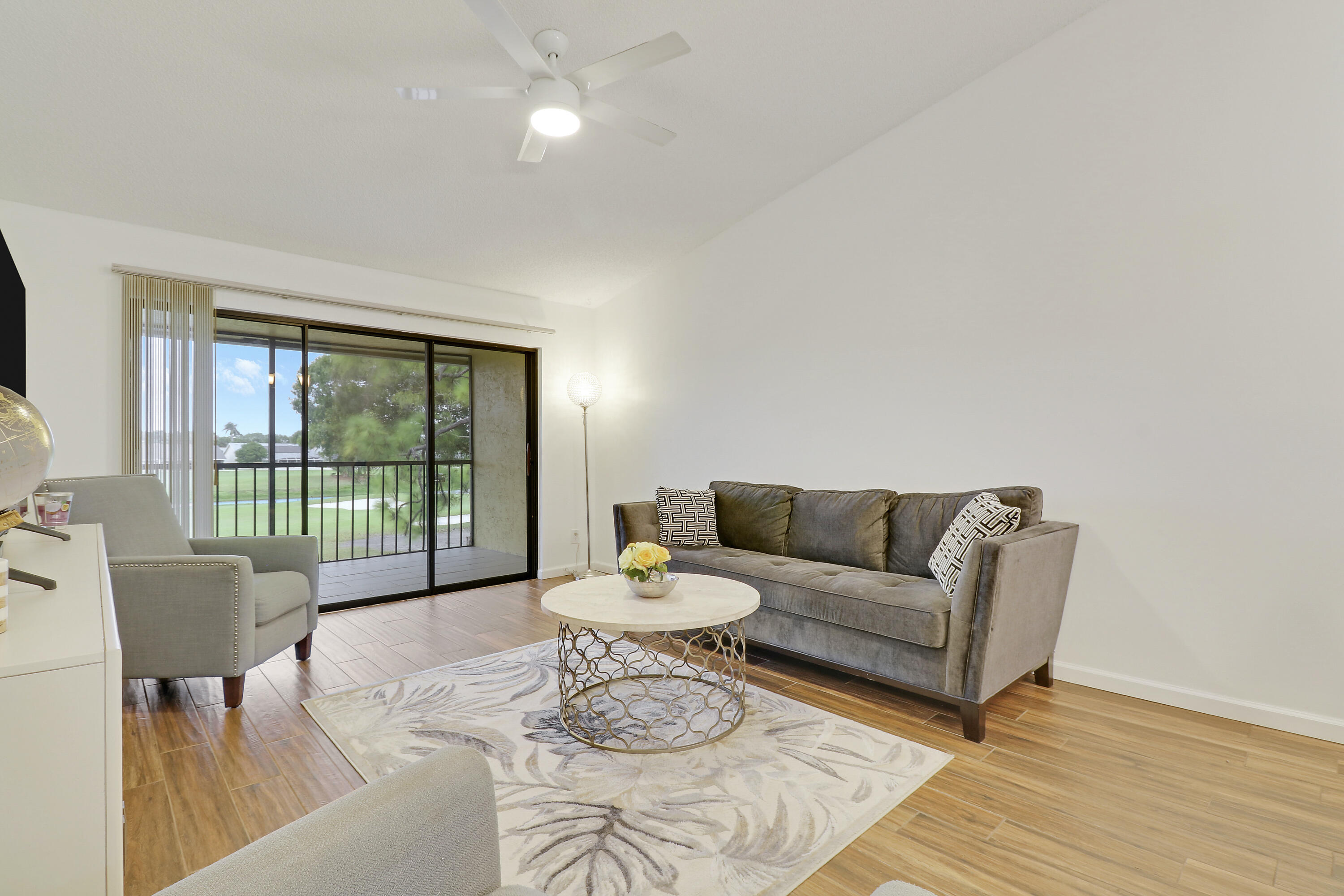 1112 Keystone Drive, Unit A Jupiter, FL 33458 - Photo 6 of 41 a living room with furniture and a large window with outer view