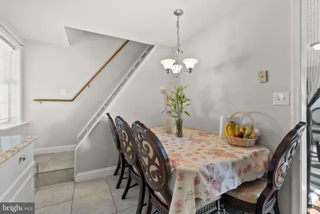 a dining room with furniture and chandelier