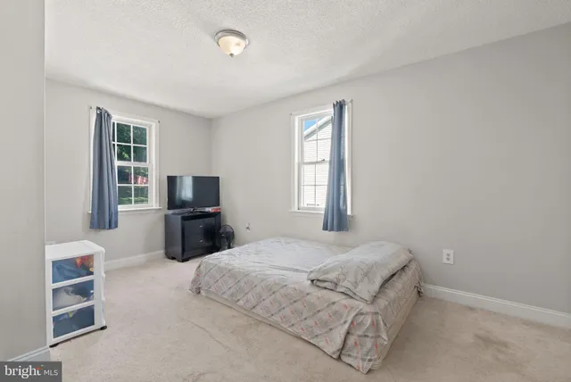 a bedroom with a bed and a television