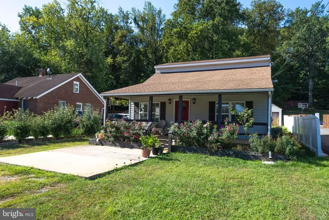 a front view of a house with yard and green space