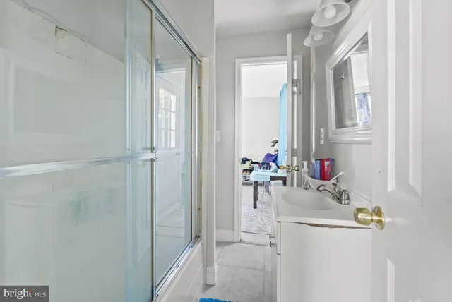a bathroom with a sink vanity and a mirror