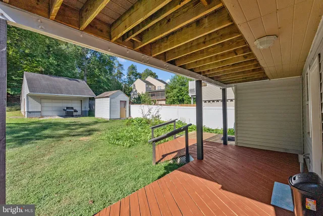 a view of house with backyard and porch