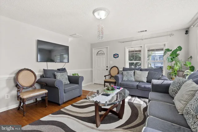 a living room with furniture a rug and a window