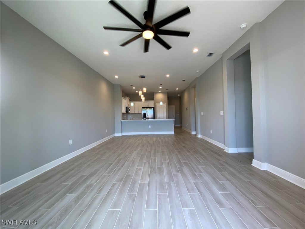 1927 Nottingham Trail Punta Gorda, FL 33980 - Photo 11 of 35 wooden floor in an empty room with a window