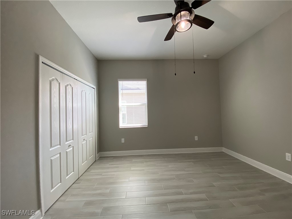 1927 Nottingham Trail Punta Gorda, FL 33980 - Photo 13 of 35 wooden floor in an empty room with a window