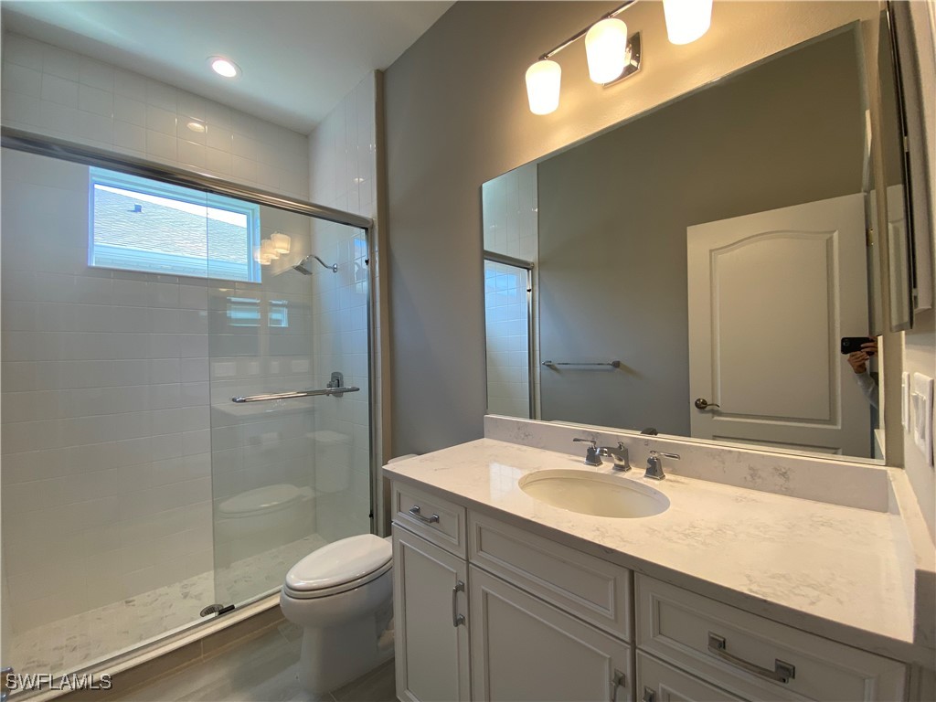 1927 Nottingham Trail Punta Gorda, FL 33980 - Photo 17 of 35 a bathroom with a granite countertop sink toilet and shower