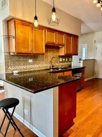 a kitchen with stainless steel appliances granite countertop a sink and a counter space