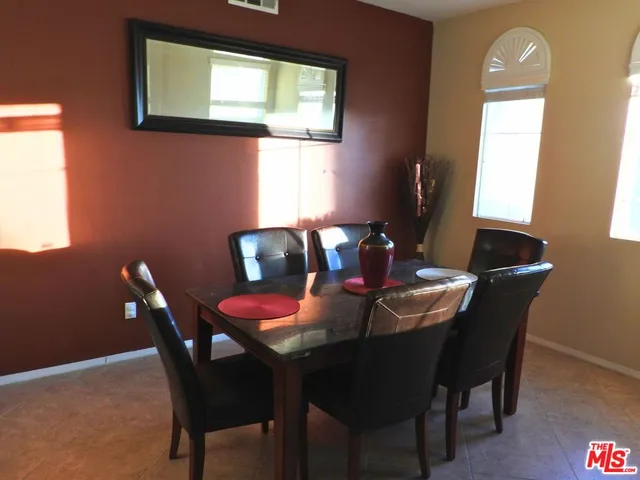 a view of a dining room with furniture and window