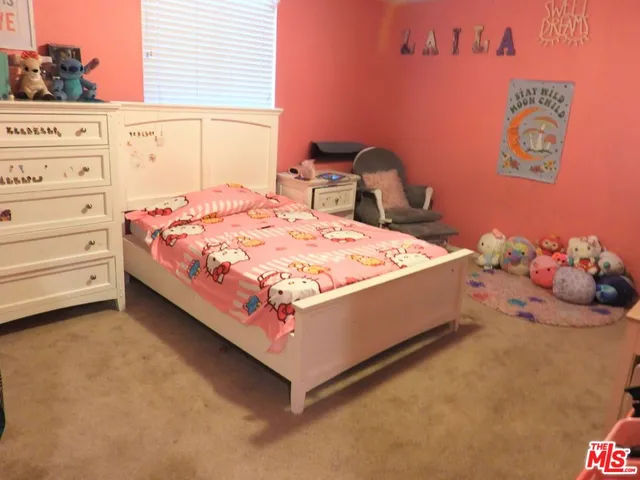 a bedroom with a bed and a lamp