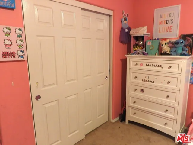 a bedroom with a bed and lamp