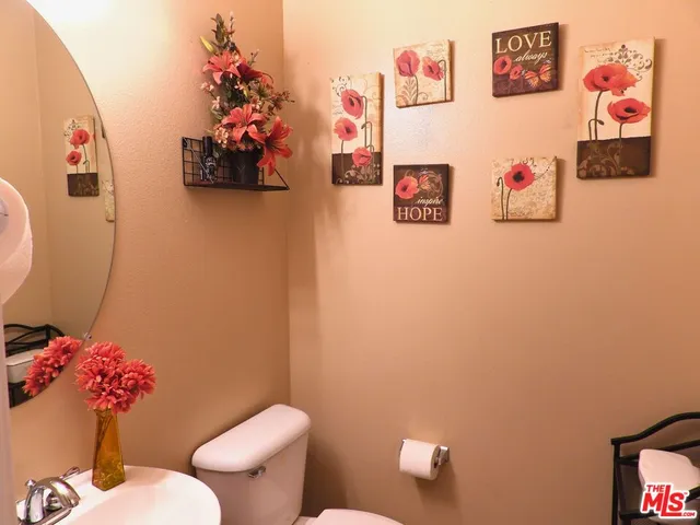 a bathroom with a toilet and a shower curtain