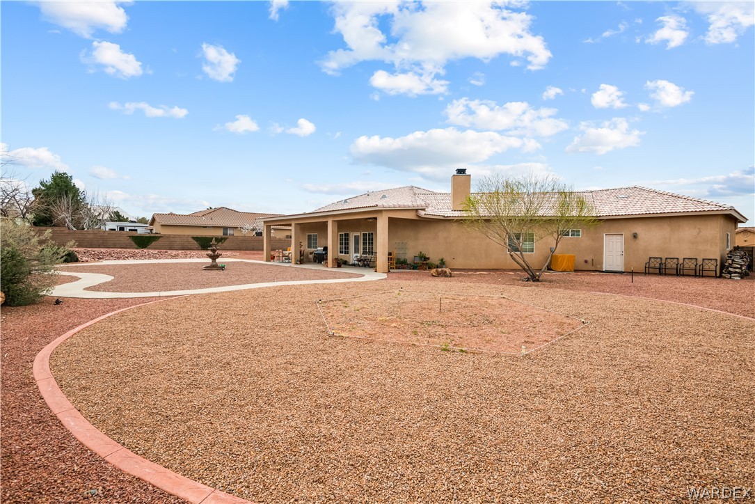 2898 Mountain Trail Road Kingman, AZ 86401 - Photo 53 of 75 a view of large house with a big yard and large trees