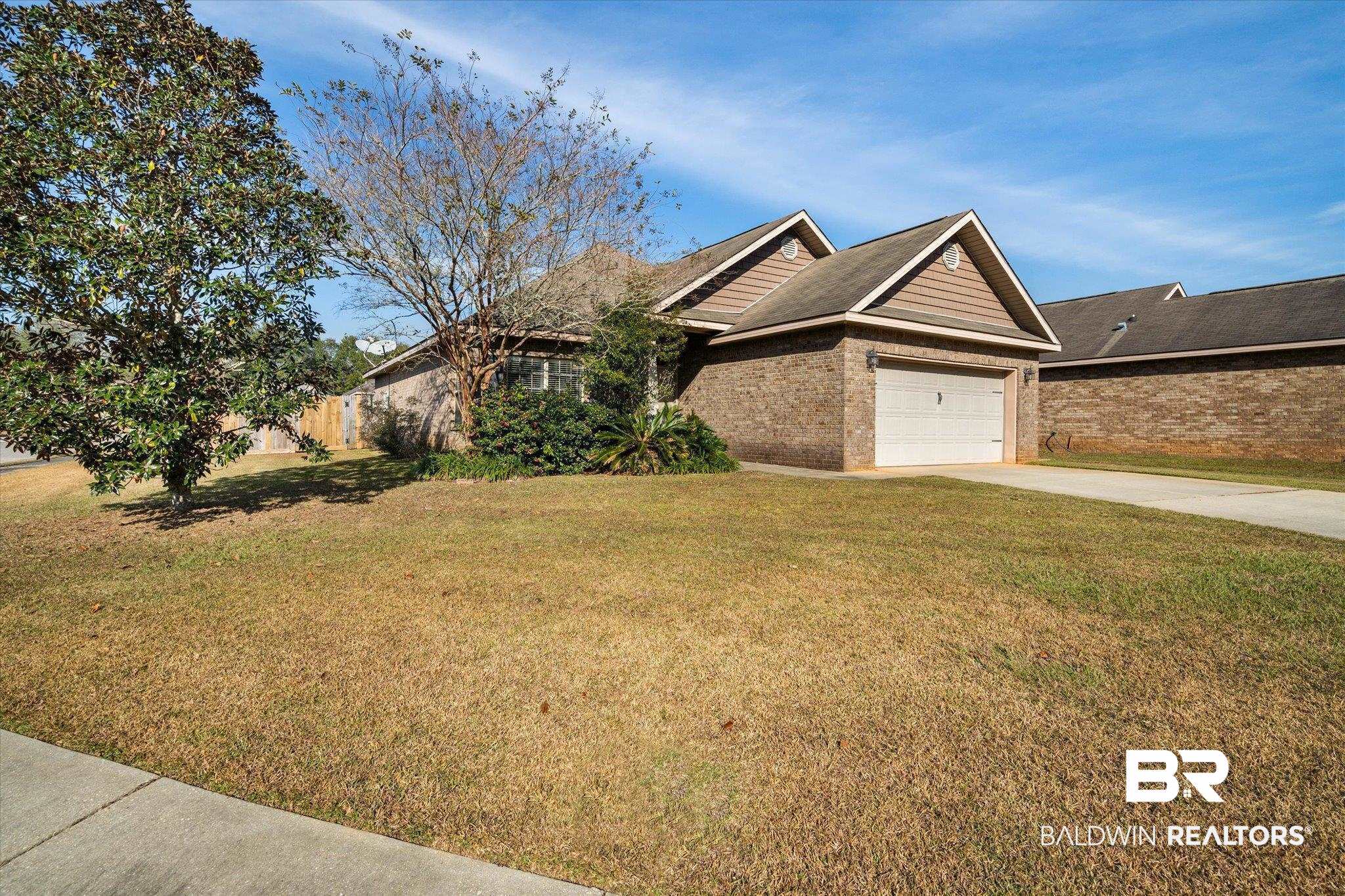 10251 Fionn Loop Daphne, AL 36526 - Photo 27 of 28 View of front of property with a garage and a front lawn