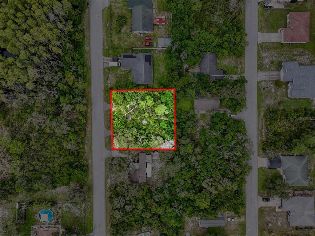 71 St 72 & 73 New Port New Port Richey, FL 34654 - Photo 20 of 37 an aerial view of a house with a yard and garden