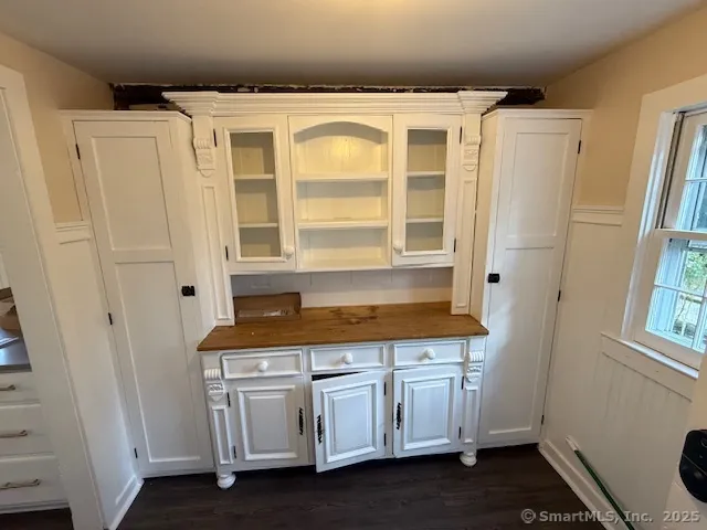 a bathroom with a granite countertop sink a mirror and a shower