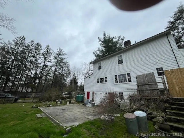 a view of backyard with deck and outdoor seating