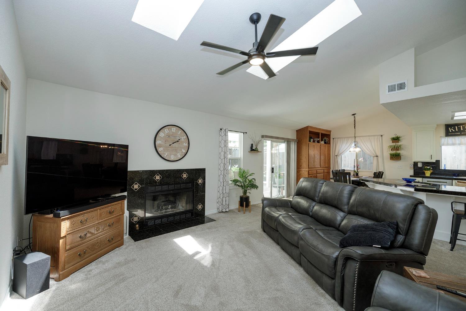 230 Meyenberg Avenue Ripon, CA 95366 - Photo 13 of 52 a living room with furniture a flat screen tv and a fireplace