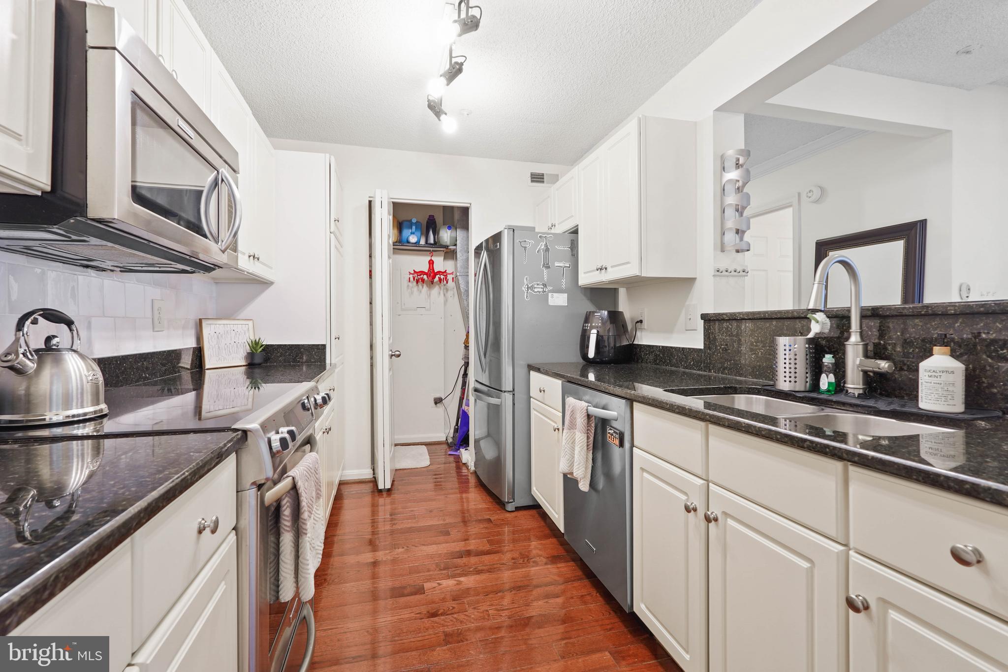 12901 Churchill Ridge Circle, Unit 13 Germantown, MD 20874 - Photo 11 of 44 a kitchen with stainless steel appliances granite countertop a sink stove and refrigerator