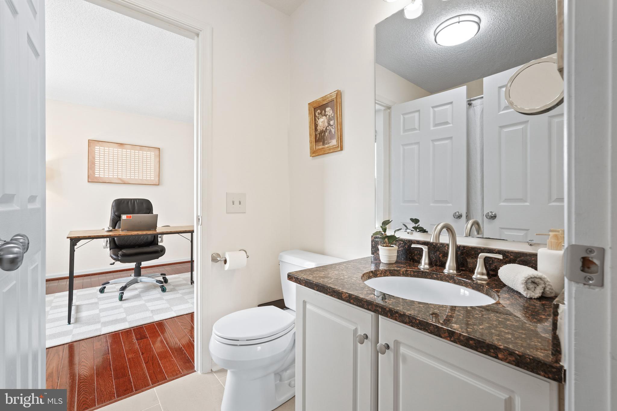12901 Churchill Ridge Circle, Unit 13 Germantown, MD 20874 - Photo 25 of 44 a bathroom with a granite countertop sink toilet and a mirror