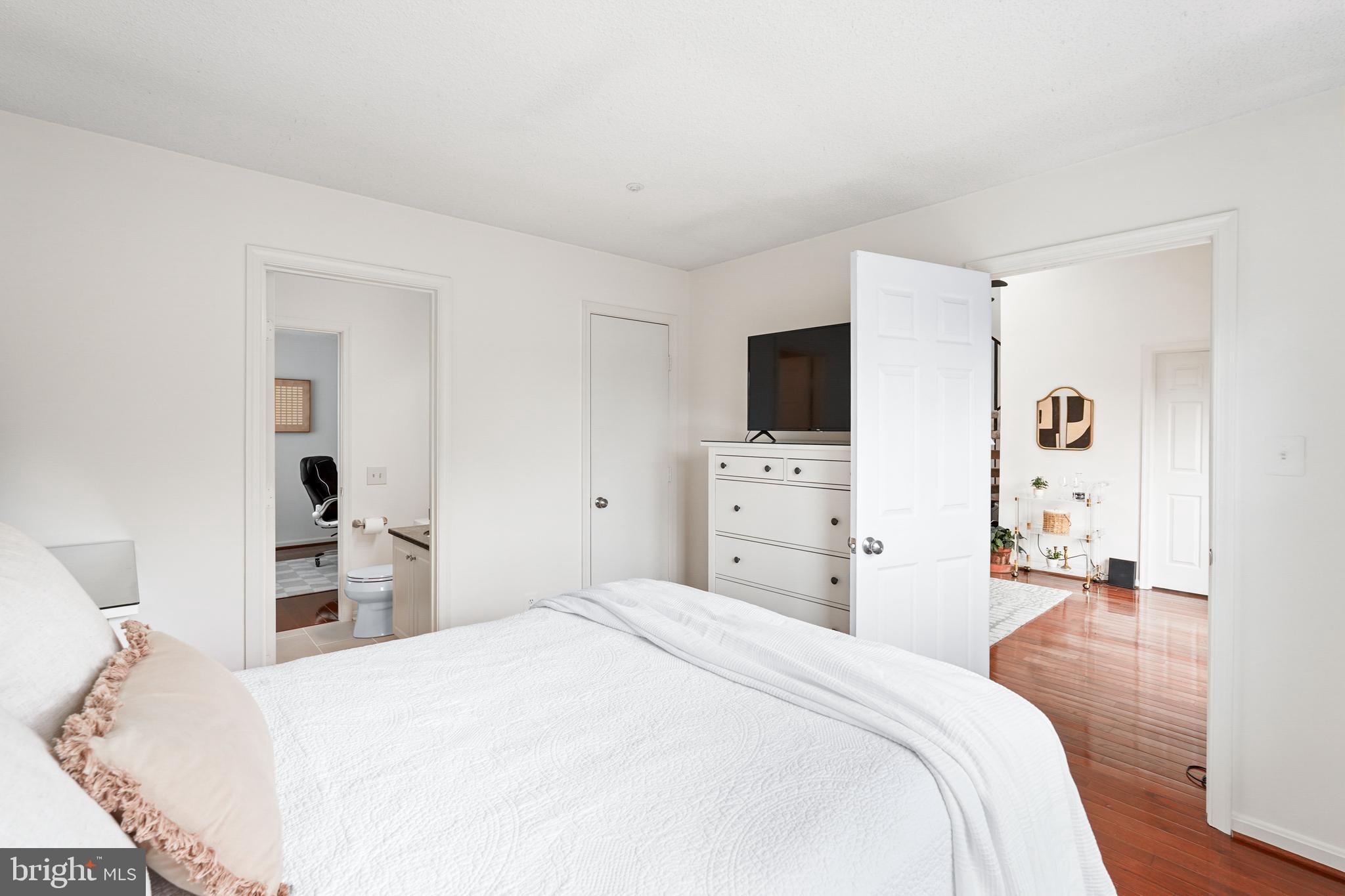 12901 Churchill Ridge Circle, Unit 13 Germantown, MD 20874 - Photo 28 of 44 a bedroom with a bed and a flat tv screen