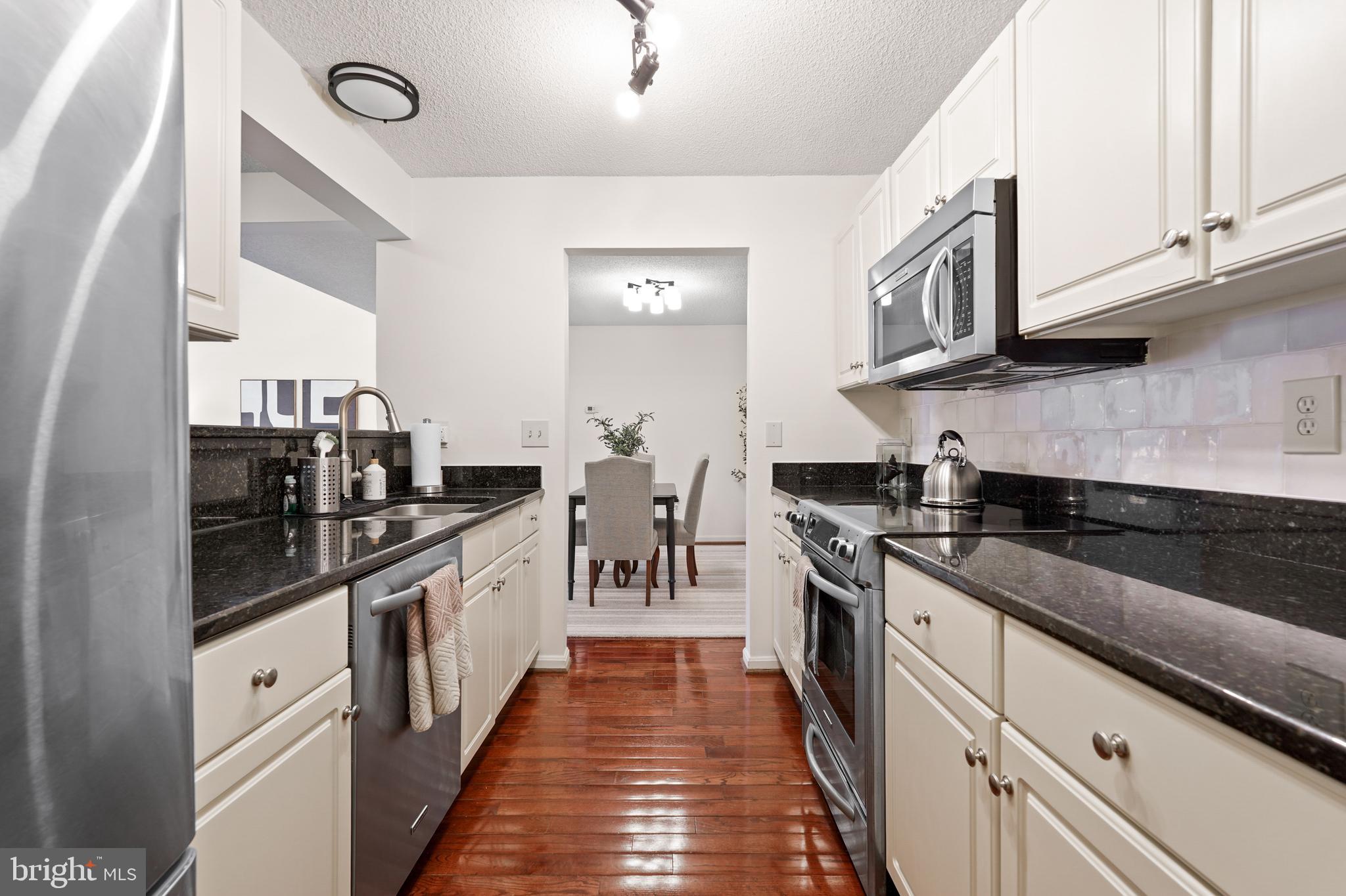 12901 Churchill Ridge Circle, Unit 13 Germantown, MD 20874 - Photo 10 of 44 a kitchen with stainless steel appliances granite countertop lots of counter space and a sink