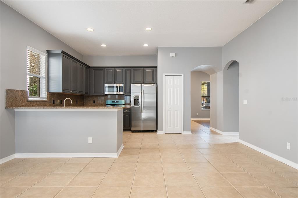 13118 Sunkiss Loop Windermere, FL 34786 - Photo 13 of 52 a large kitchen with cabinets and stainless steel appliances