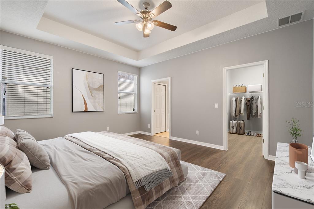 13118 Sunkiss Loop Windermere, FL 34786 - Photo 23 of 52 a bedroom with a large bed and a chandelier