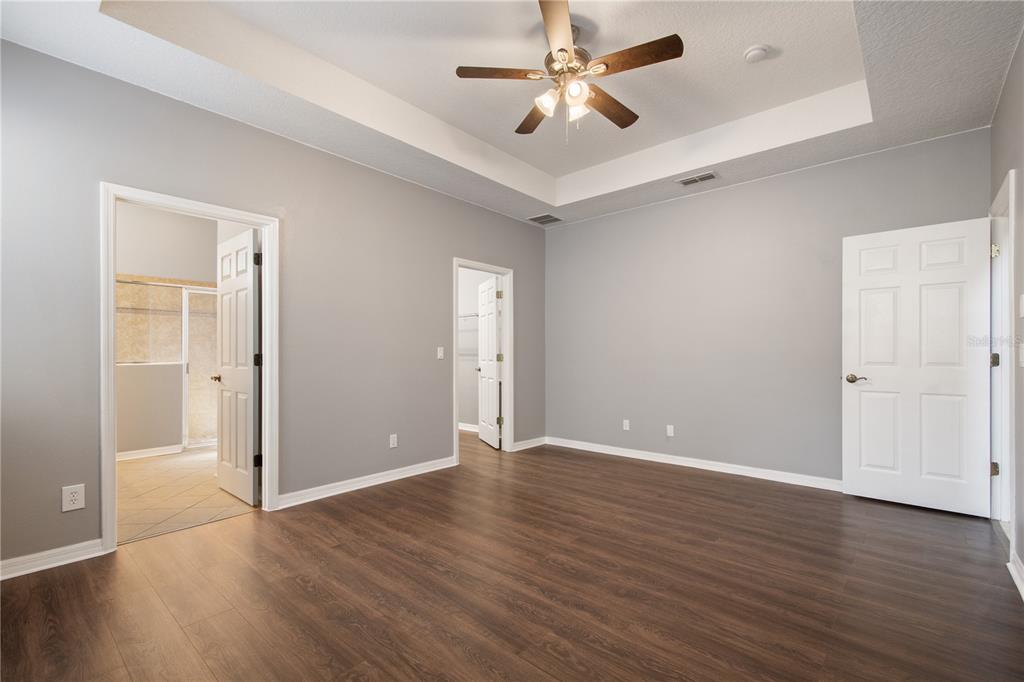13118 Sunkiss Loop Windermere, FL 34786 - Photo 24 of 52 an empty room with wooden floor and ceiling fan