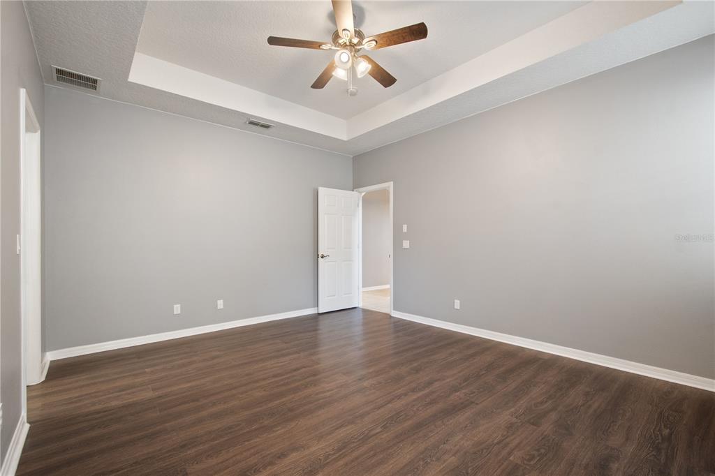 13118 Sunkiss Loop Windermere, FL 34786 - Photo 25 of 52 a view of an empty room with window and wooden floor