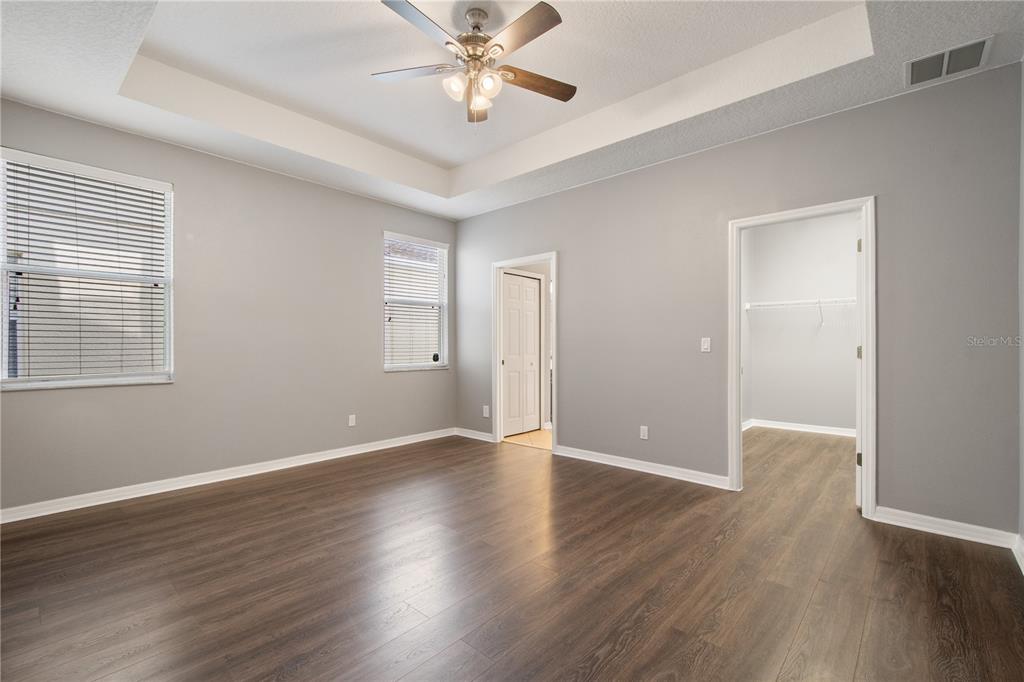 13118 Sunkiss Loop Windermere, FL 34786 - Photo 26 of 52 a view of an empty room with wooden floor and a window