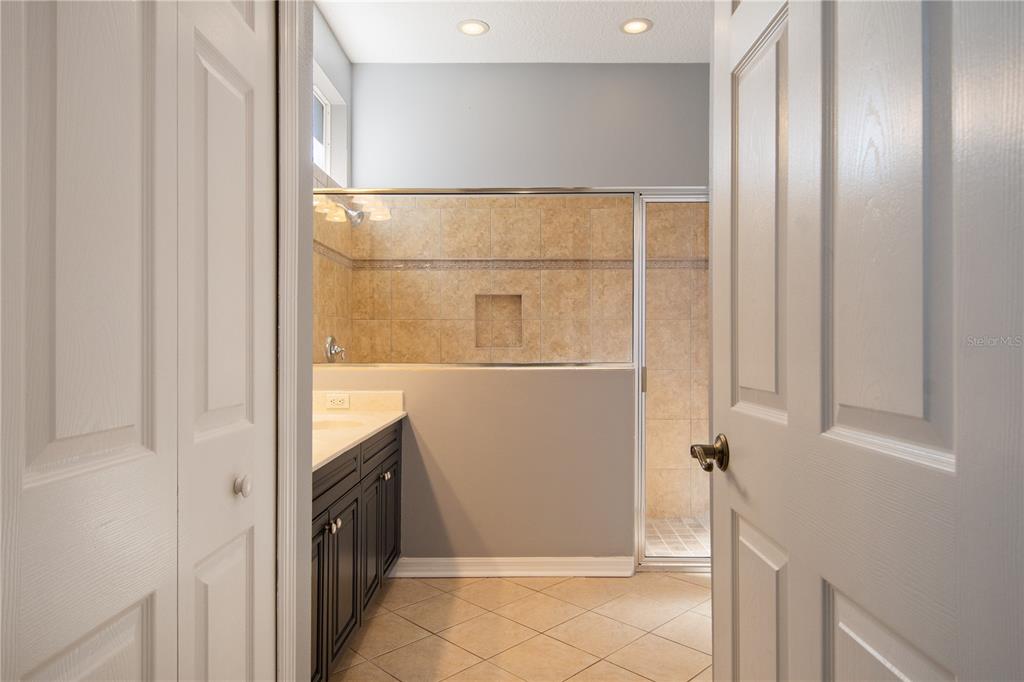 13118 Sunkiss Loop Windermere, FL 34786 - Photo 28 of 52 a bathroom with a mirror and a shower