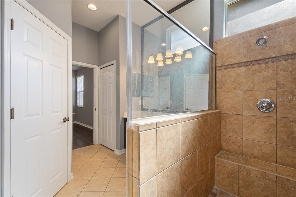 13118 Sunkiss Loop Windermere, FL 34786 - Photo 31 of 52 a bathroom with a mirror and a shower