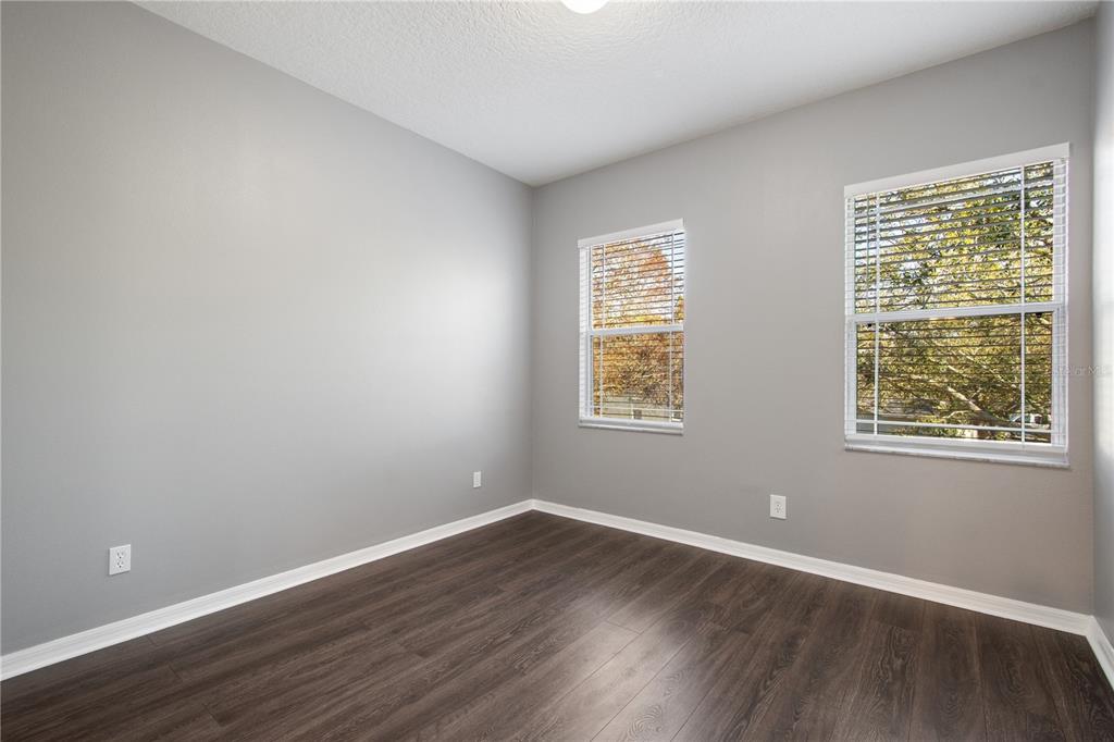 13118 Sunkiss Loop Windermere, FL 34786 - Photo 35 of 52 a view of an empty room with wooden floor and a window