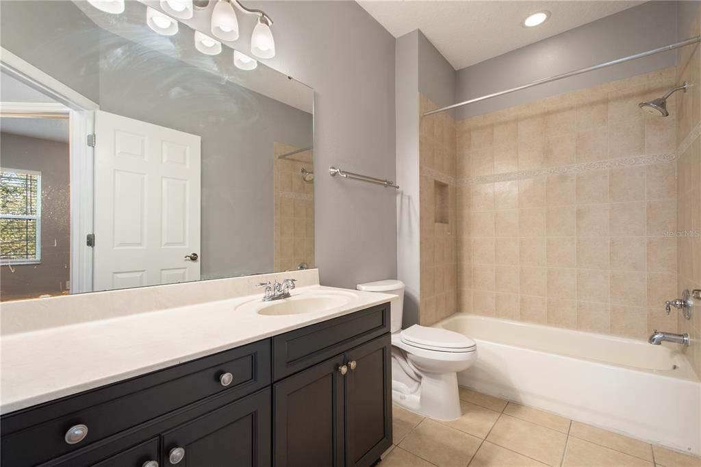 13118 Sunkiss Loop Windermere, FL 34786 - Photo 36 of 52 a bathroom with a sink a toilet and a large mirror