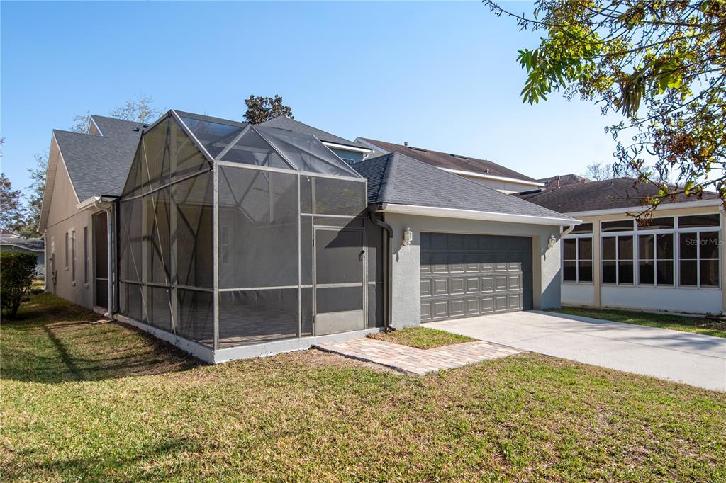 13118 Sunkiss Loop Windermere, FL 34786 - Photo 46 of 52 a view of a house with a small yard and a large tree
