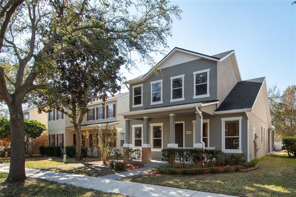 13118 Sunkiss Loop Windermere, FL 34786 - Photo 49 of 52 a front view of a house with garden and trees