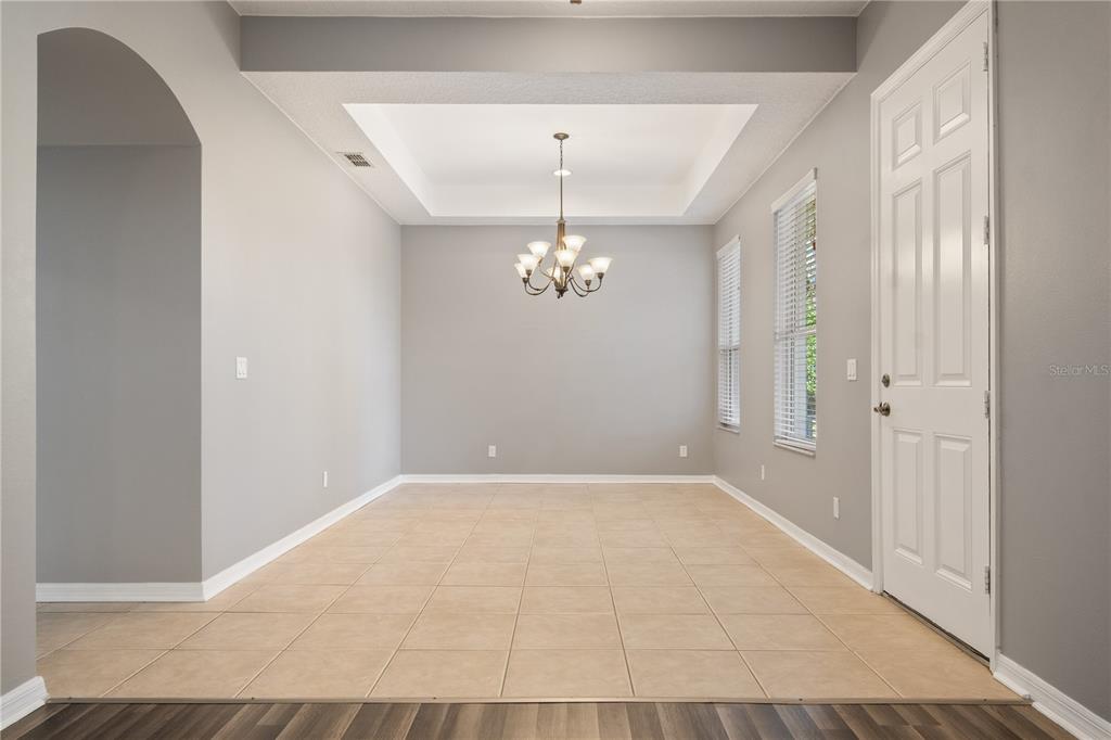 13118 Sunkiss Loop Windermere, FL 34786 - Photo 9 of 52 an empty room with chandelier fan and windows