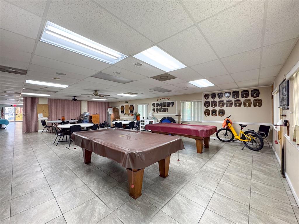 6433 Tina Drive, Unit 12 New Port Richey, FL 34653 - Photo 21 of 24 a room with furniture and lots of windows