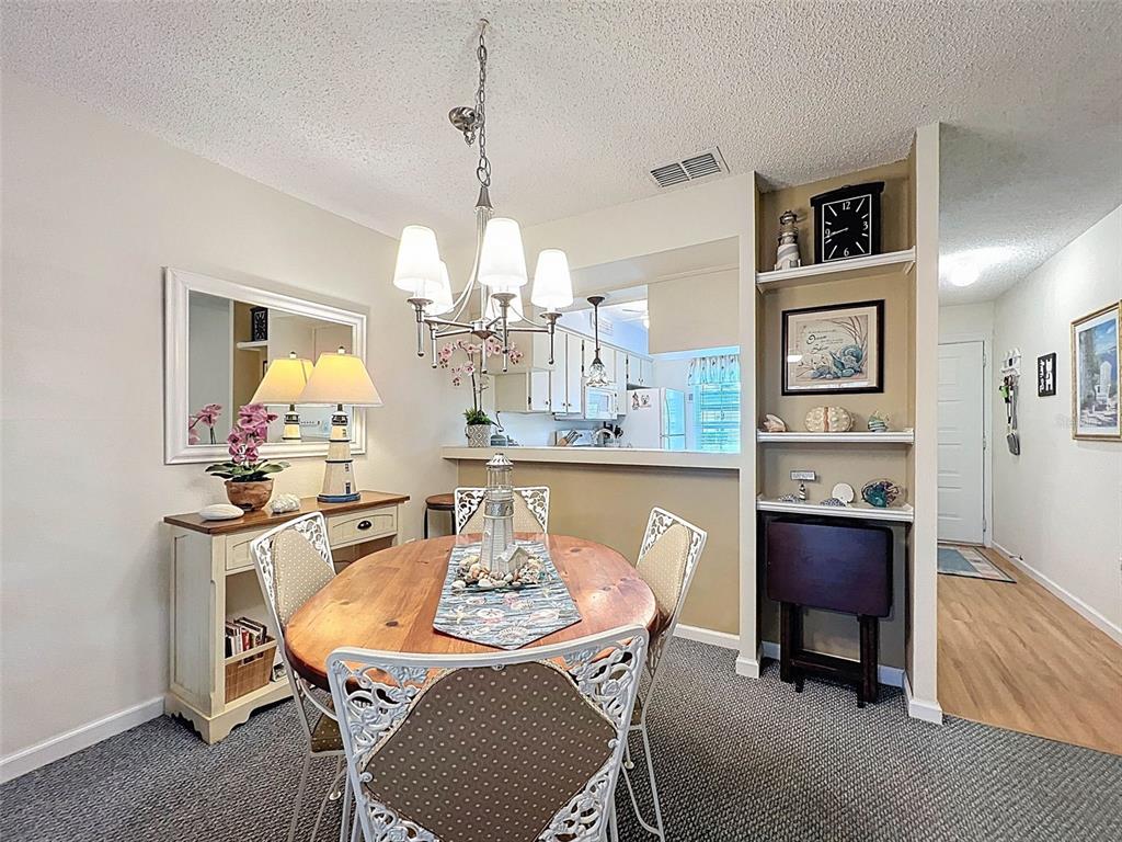 6433 Tina Drive, Unit 12 New Port Richey, FL 34653 - Photo 3 of 24 a view of a dining room with furniture