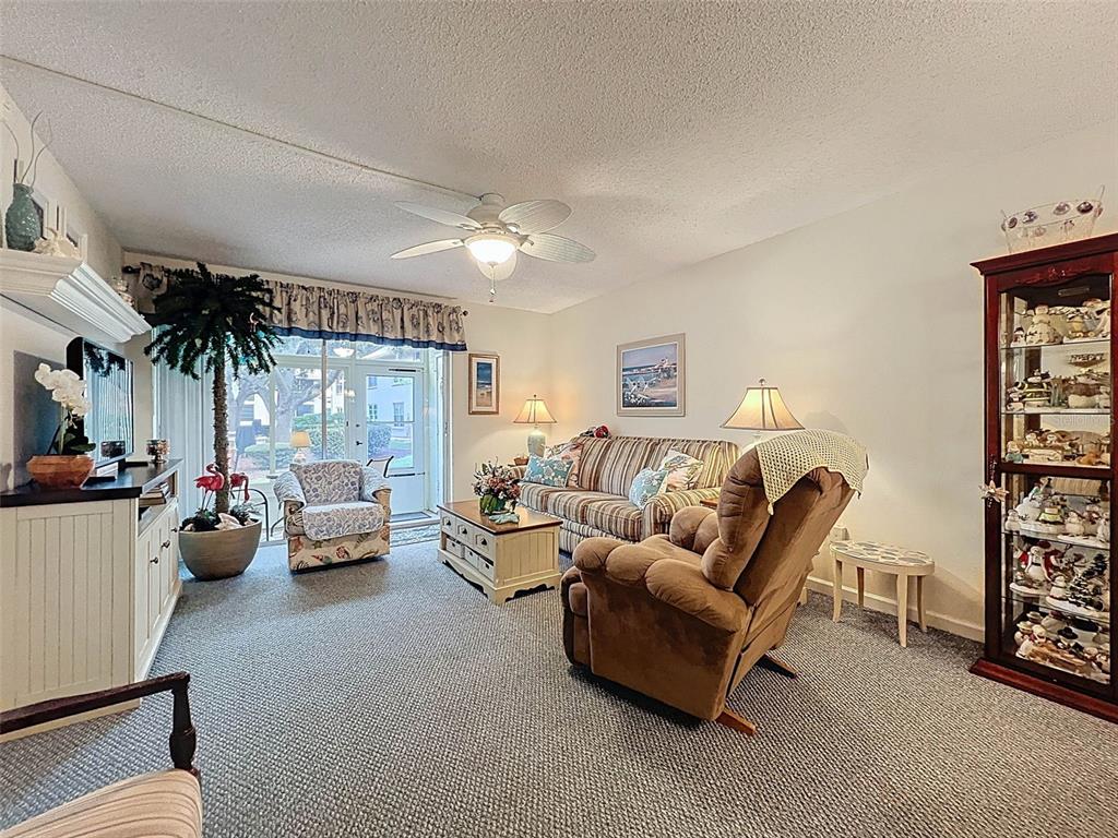 6433 Tina Drive, Unit 12 New Port Richey, FL 34653 - Photo 6 of 24 a living room with furniture and a large window